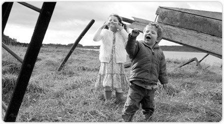 Children pulling faces and pretending to knock on door